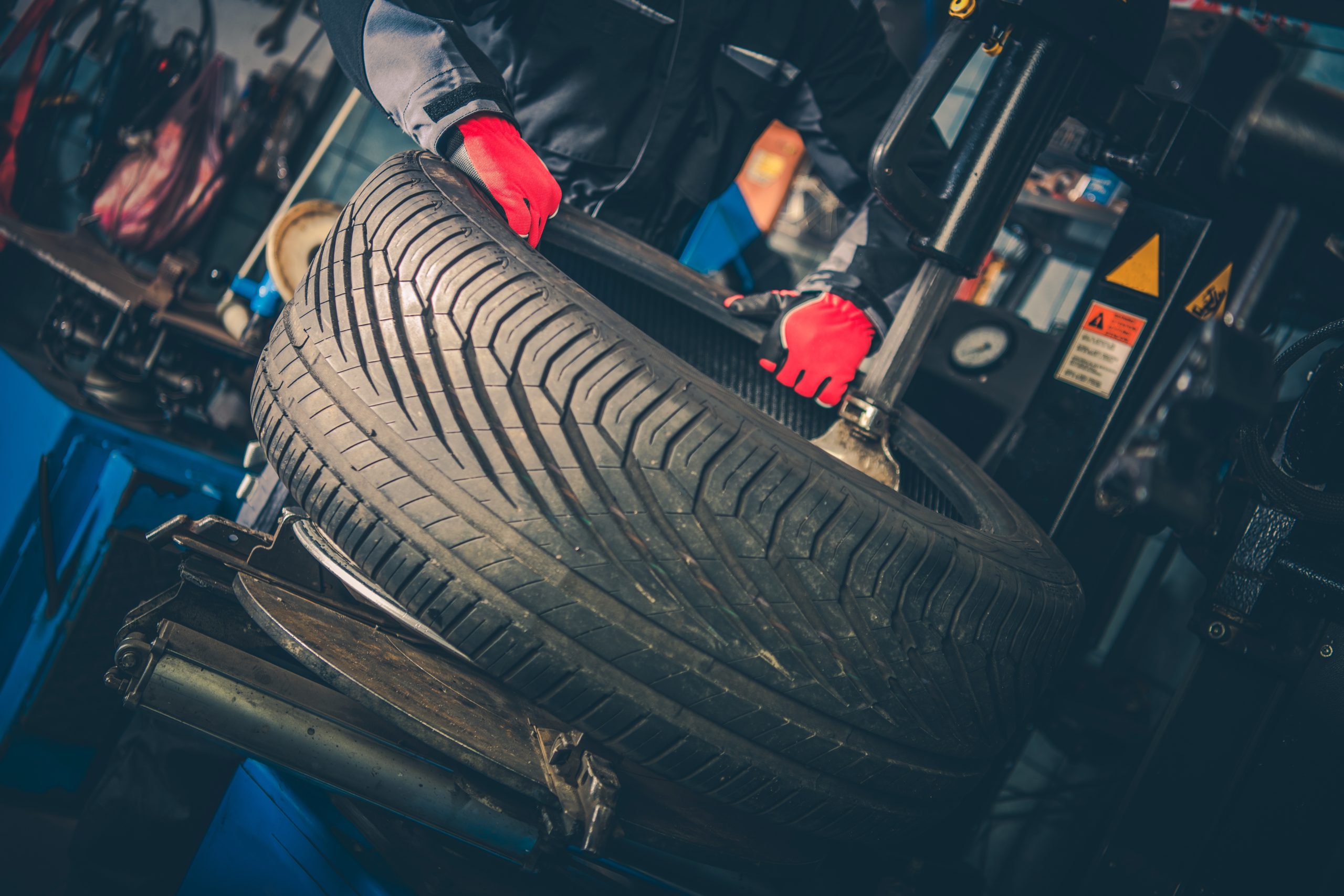 Mechanic in tire shop performing tire installation